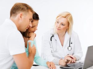 doctor counsels woman and man